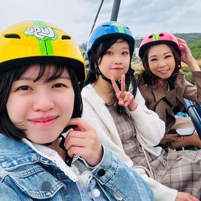 A group of friends ride the Skyride at Skyline Luge Busan.